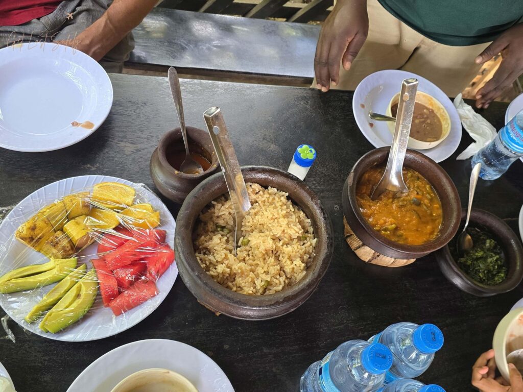 Variety of traditional meals served at Materuni Homes, Tanzania. Fruits, rice and chicken meat.